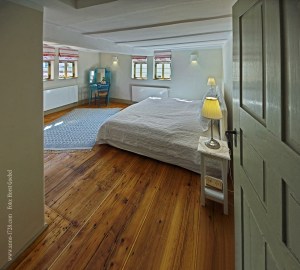 The master bedroom has a king sized bed and a wardrobe.